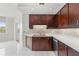 Kitchen with dark wood cabinets and white countertops at 1 Seaside Ln # 104, Belleair, FL 33756