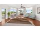 Main bedroom with hardwood floors and access to balcony at 1 Seaside Ln # 104, Belleair, FL 33756