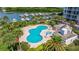 Aerial view of resort-style pool and spa with lush landscaping at 1 Seaside Ln # 104, Belleair, FL 33756
