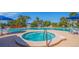 Community pool and spa with lounge chairs and umbrellas at 1 Seaside Ln # 104, Belleair, FL 33756