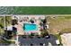 Aerial view of a condo's outdoor pool, lounge area, parking, and waterfront access at 6075 Shore S Blvd # 501, Gulfport, FL 33707