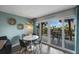 Casual dining area with white table and chairs, overlooking balcony at 7537 Bayshore Dr # 303, Treasure Island, FL 33706