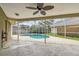 Screened-in pool area with patio and ceiling fan at 500 Waterford W Cir, Tarpon Springs, FL 34688