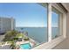 Lovely water view from window, including a pool, beach area, and open water at 6075 Shore S Blvd # 501, Gulfport, FL 33707