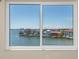 Stunning water view from window, showcasing waterfront homes and blue skies at 6075 Shore S Blvd # 501, Gulfport, FL 33707