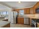 Modern kitchen with wood cabinets and granite countertops at 6075 Shore S Blvd # 501, Gulfport, FL 33707