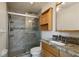 Bathroom features granite countertop, walk-in shower, and wood cabinet at 6075 Shore S Blvd # 501, Gulfport, FL 33707