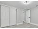 Bedroom with grey flooring, white doors and ceiling fan at 9124 Lido Ln, Port Richey, FL 34668