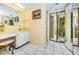 Bathroom with mirror, vanity, tile floor, and access to toilet and shower rooms at 300 Woodette Dr # 202B, Dunedin, FL 34698