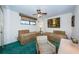 Bedroom featuring two beds, side tables, carpet and window with blinds at 300 Woodette Dr # 202B, Dunedin, FL 34698