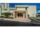 Welcoming entrance to building 250 with brick paving and well-maintained landscaping at 300 Woodette Dr # 202B, Dunedin, FL 34698
