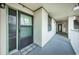 Welcome mat leading into condo with painted door and storm door at 300 Woodette Dr # 202B, Dunedin, FL 34698
