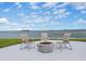 Scenic waterfront view with outdoor seating around a modern fire pit, perfect for relaxing and enjoying the beautiful scenery at 300 Woodette Dr # 202B, Dunedin, FL 34698