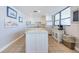 Bright kitchen featuring a center island, stainless appliances, and an abundance of natural light at 300 Woodette Dr # 202B, Dunedin, FL 34698