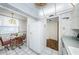 Bright eat-in kitchen area with white appliances and cabinetry and adjacent dining area at 300 Woodette Dr # 202B, Dunedin, FL 34698