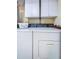 Laundry room featuring a white washer and dryer with white storage cabinets above at 300 Woodette Dr # 202B, Dunedin, FL 34698