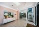 Lobby area featuring tile floors, a decorative console table, and stair access to other floors at 300 Woodette Dr # 202B, Dunedin, FL 34698