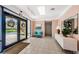 Well-lit lobby with tile floors, comfortable seating, seasonal decorations, and direct exterior access at 300 Woodette Dr # 202B, Dunedin, FL 34698