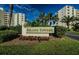 Attractive Island Towers sign with well-maintained landscaping and palm trees on a sunny day at 300 Woodette Dr # 202B, Dunedin, FL 34698