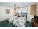 Bedroom with two twin beds, water view, and green carpet at 300 Woodette Dr # 202B, Dunedin, FL 34698