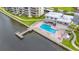Aerial view of resort-style pool with dock access at 300 Woodette Dr # 202B, Dunedin, FL 34698
