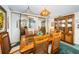 Bright dining room features a wood table with seating for six and a built-in hutch at 300 Woodette Dr # 202B, Dunedin, FL 34698
