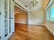Bedroom featuring hardwood floors, a window, and barn doors at 100 Bluff View Dr # 208B, Belleair Bluffs, FL 33770