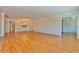 Open living area with hardwood floors and views to kitchen at 100 Bluff View Dr # 208B, Belleair Bluffs, FL 33770