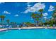 Inviting community pool area with lounge chairs and waterfront view at 100 Bluff View Dr # 208B, Belleair Bluffs, FL 33770