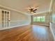 Bright bedroom featuring hardwood floors and a ceiling fan at 100 Bluff View Dr # 208B, Belleair Bluffs, FL 33770