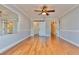 Hardwood floor bedroom with barn door and mirrored wall at 100 Bluff View Dr # 208B, Belleair Bluffs, FL 33770