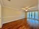 Bright bedroom featuring hardwood floors and French doors leading outside at 100 Bluff View Dr # 208B, Belleair Bluffs, FL 33770