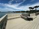 Community pier with seating area and wooden railings at 100 Bluff View Dr # 208B, Belleair Bluffs, FL 33770
