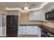 Kitchen with white cabinets, granite countertops, and stainless steel appliances at 100 Bluff View Dr # 208B, Belleair Bluffs, FL 33770
