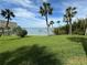 Stunning waterfront view with lush landscaping and private dock at 100 Bluff View Dr # 208B, Belleair Bluffs, FL 33770