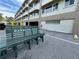 Building exterior showcasing parking and a welcoming bench at 100 Bluff View Dr # 208B, Belleair Bluffs, FL 33770