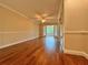 Spacious bedroom with hardwood floors and access to a private patio at 100 Bluff View Dr # 208B, Belleair Bluffs, FL 33770