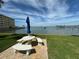 Seating area overlooking the water with table and umbrella at 100 Bluff View Dr # 208B, Belleair Bluffs, FL 33770