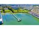 Aerial view of waterfront property with boat dock and building at 100 Bluff View Dr # 208B, Belleair Bluffs, FL 33770