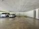 Underground parking garage with several parking spots and cars at 100 Bluff View Dr # 208B, Belleair Bluffs, FL 33770