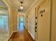 Hallway with hardwood floors and access to unit 208 at 100 Bluff View Dr # 208B, Belleair Bluffs, FL 33770