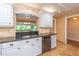 Kitchen features white cabinets, granite countertops, and stainless steel appliances at 100 Bluff View Dr # 208B, Belleair Bluffs, FL 33770