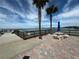 Private waterfront patio with seating and umbrella at 100 Bluff View Dr # 208B, Belleair Bluffs, FL 33770