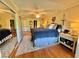 Main bedroom with mirrored closet doors and hardwood floors at 100 Bluff View Dr # 208B, Belleair Bluffs, FL 33770