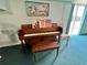 Living room features a vintage upright piano at 100 Bluff View Dr # 208B, Belleair Bluffs, FL 33770
