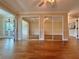 Hardwood floor bedroom with mirrored closet doors and access to other rooms at 100 Bluff View Dr # 208B, Belleair Bluffs, FL 33770
