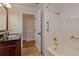 Elegant bathroom with a tub, shower, and dark vanity at 100 Bluff View Dr # 208B, Belleair Bluffs, FL 33770