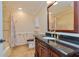 Bathroom with dark vanity, tub and shower at 100 Bluff View Dr # 208B, Belleair Bluffs, FL 33770