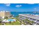 Aerial view showing a waterfront community with a pool and bay views at 100 Bluff View Dr # 208B, Belleair Bluffs, FL 33770