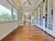 Bright bedroom with hardwood floors, ceiling fan, and barn doors at 100 Bluff View Dr # 208B, Belleair Bluffs, FL 33770